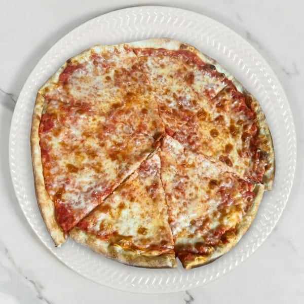 A whole cheese pizza, sliced into six pieces, on a white plate.