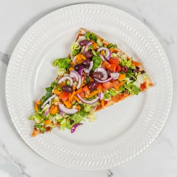 A single slice of pizza topped with fresh lettuce, tomatoes, red onions, olives, and bell peppers.